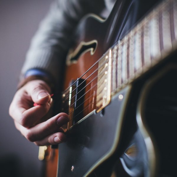 Canva - Person Playing Brown and Black Guitar